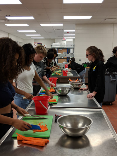 Third and fourth hour culinary arts students practicing their cutting skills.