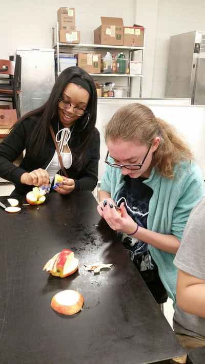 Culinary 3 and 4 student creating an apple swan.  