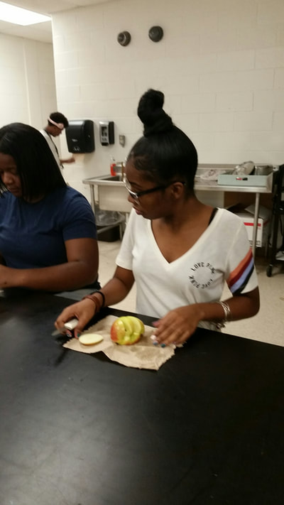 Culinary 5and 6 sdtudent working on creating an apple swan.  