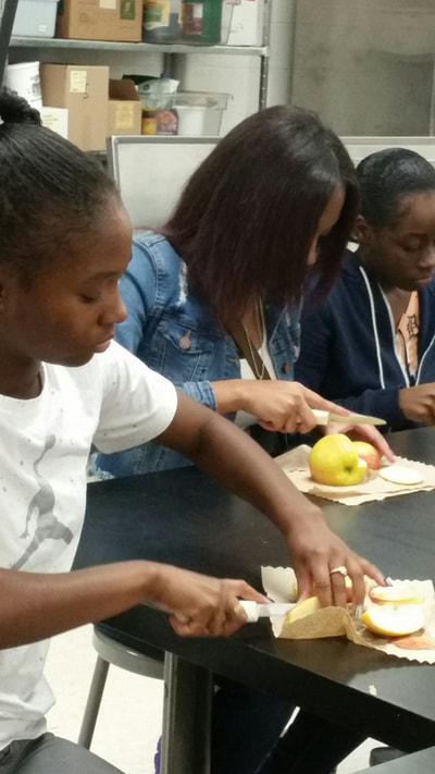 Culinary 5 and 6 student working on creating an apple swan.  