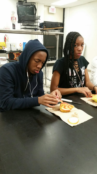 Culinary 5 and 6 students working on creating apple swans.  
