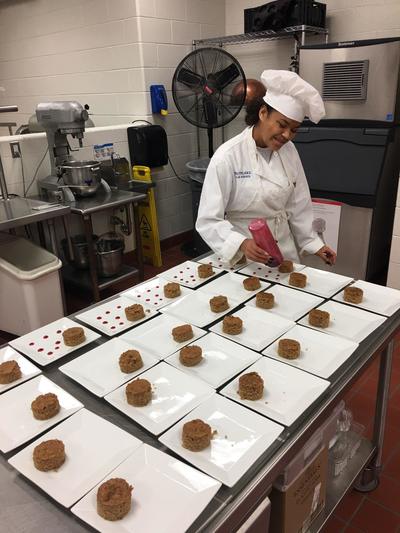 Student chef creating Michigan Apple dessert