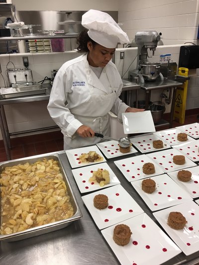Student chef creating Michigan Apple dessert
