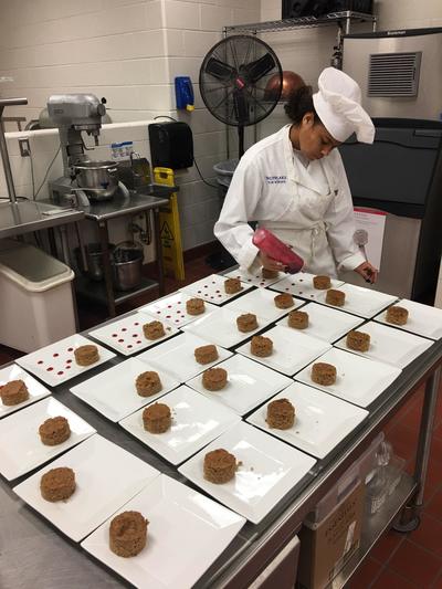 Student chef creating Michigan Apple dessert