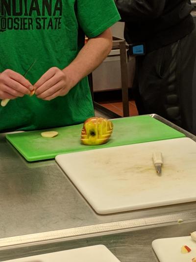 Food student working on their apple swan