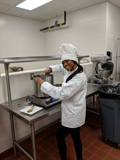 Female student posing while mixing caramel topping
