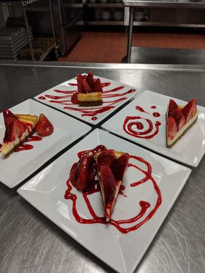 four plated strawberry cheesecake
