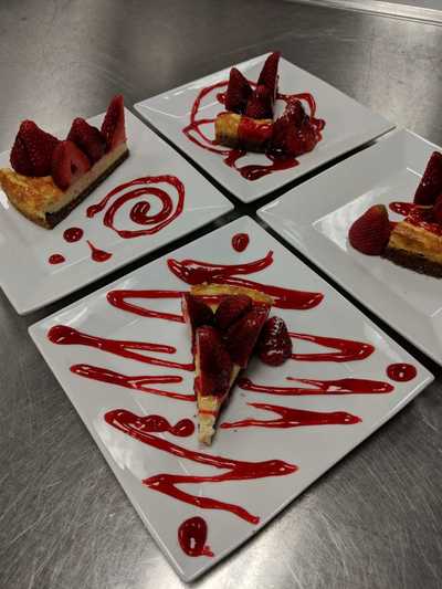 four cheesecakes dressed and plated