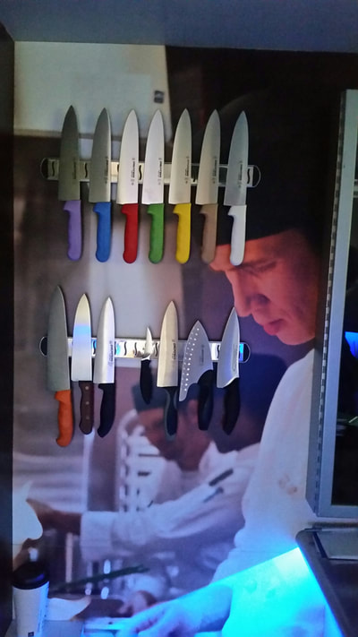 Knife exhibit with different colored handel knives and different types.