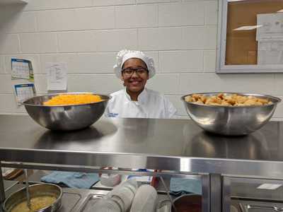 Student chef waiting to serve salad and soup to staff before the event began.