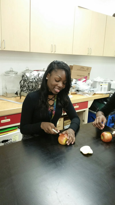 foods student creating an apple swan. 