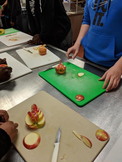 Students working on apple swans
