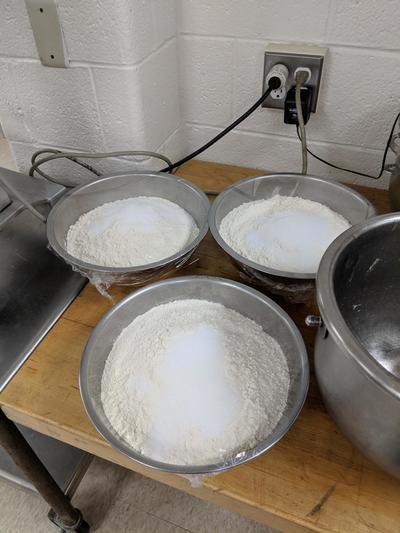 Three large bowls of flour to make bread.
