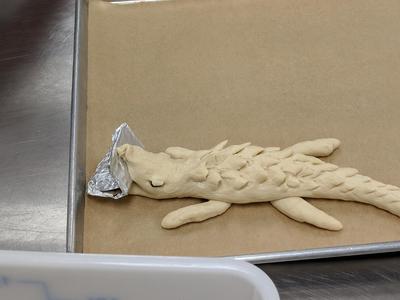Bread dough shaped into an alligator.