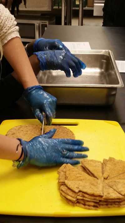 Students cutting up the homemade pita bread.
