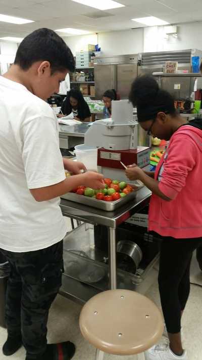 Students working with tomatoes.