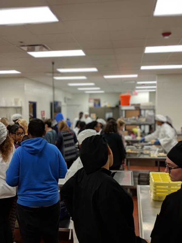 Picture of the kitchen full of students creating lunch