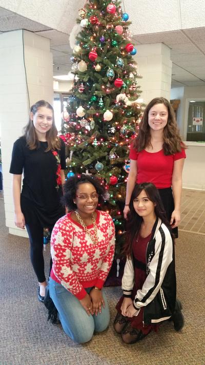 four girls from band group named Ohanas who provided the entertainment posing in front of christmas tree