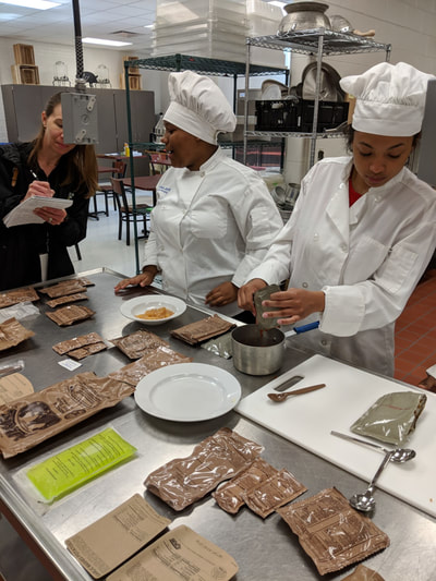 Students working at creating their new meals with MREs.