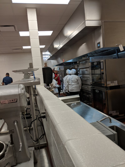 Students cooking at ovens. 