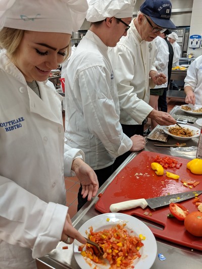 Students cutting up their ingredients.