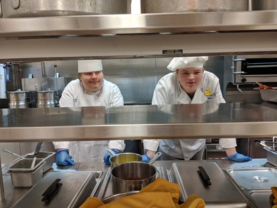 two student chefs posing for picture
