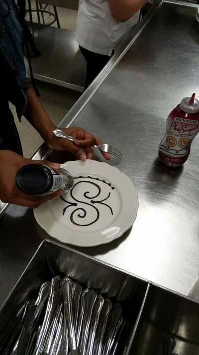 plate decorated with chocolate sauce in a butterfly pattern