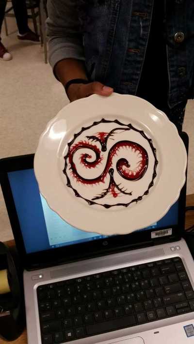 centipede style design on a plate with chocolate and strawberry sauce
