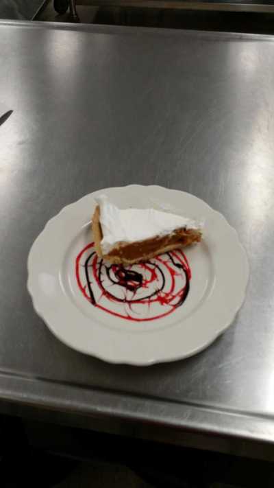pie served on a plate decorated with strawberry and chocolate sauce - foods