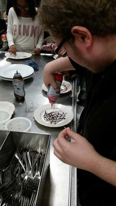 plate decorating with red and chocolate sauche - foods