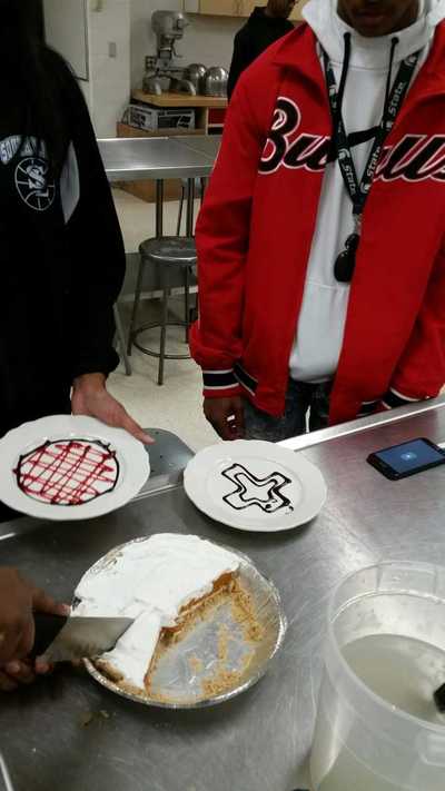two plates decorated with a chocolate cross and a criss cross design in strawberry