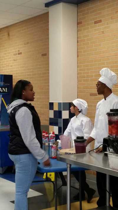 Student purchasing a smoothie in cafeteria