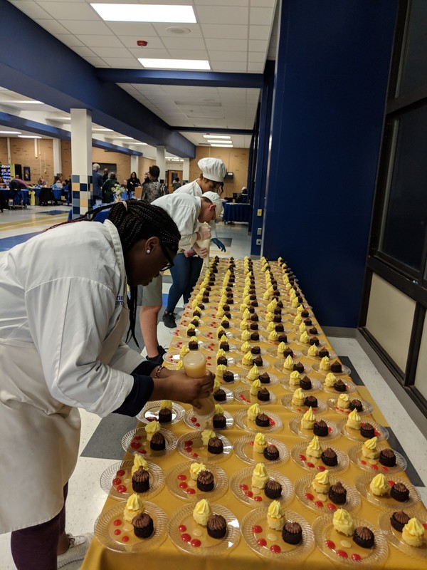 Student chefs creating desserts