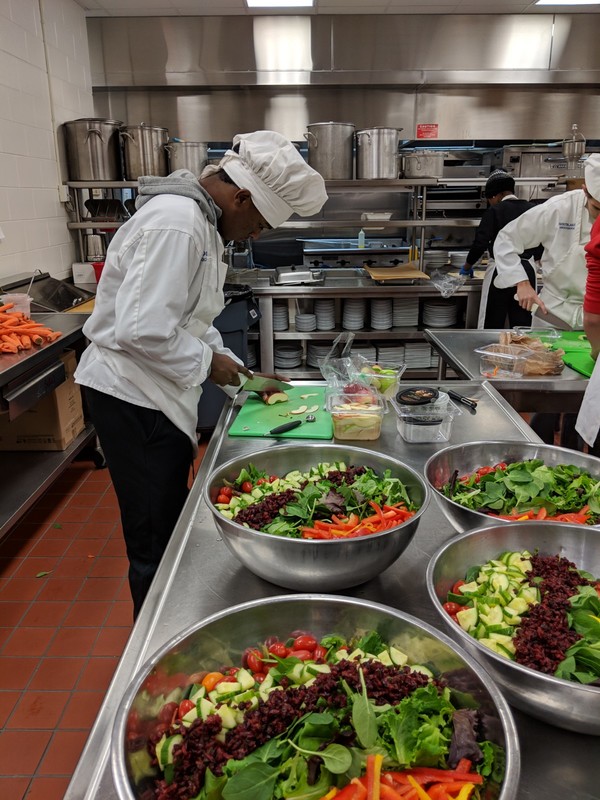 Salads being created for the athletic event 