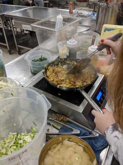 Student cooking fried rice.