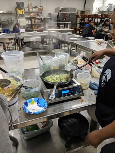 Student cooking fried rice.