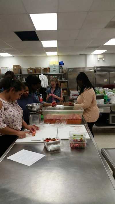Students cutting strawberries.