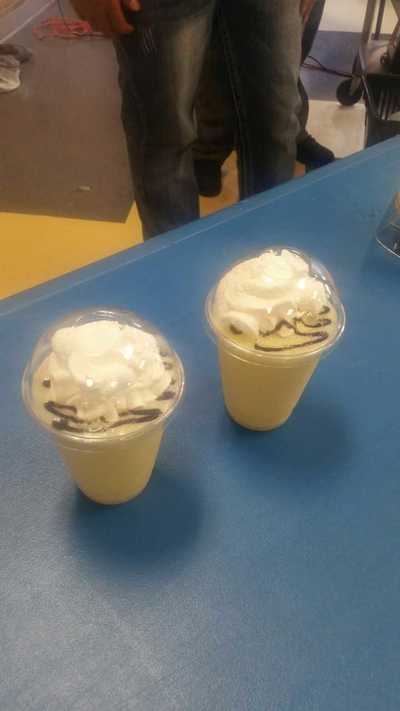 two tropical thunder smoothies with chocolate and whipped cream on top
