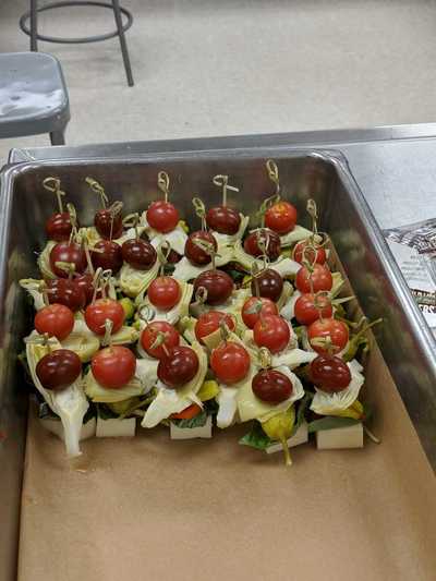 appetizers of cheese, tomatoes, lettuce, olives