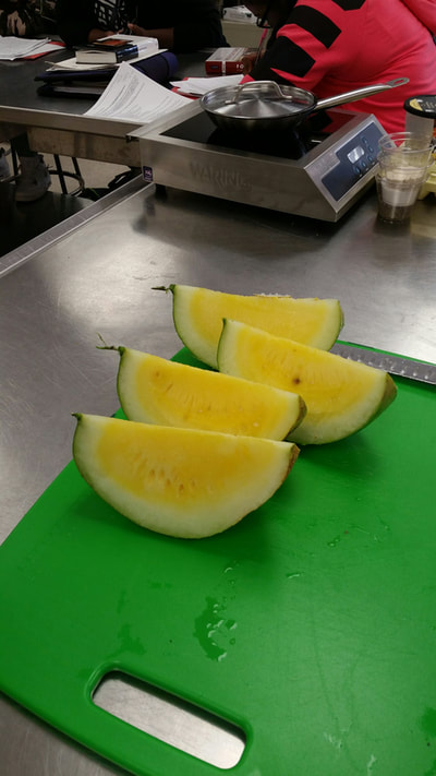 Yellow watermelon sliced in 4 sections.